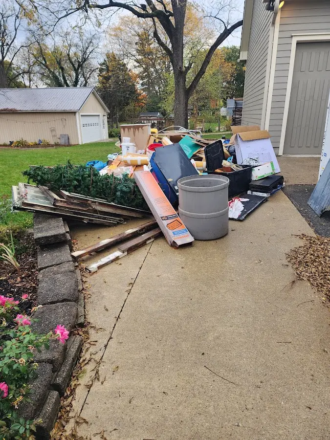 Dumpster being loaded with debris for Estate Cleanout Dumpster Rental in Meredith